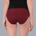 Maroon  maternity underwear worn by a person on a gray background