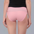 Person wearing pink  maternity underwear on a gray background