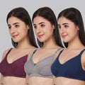 Three women modeling three different  maternity bra colors: a deep plum purple, a heather gray, and a navy blue, shown against a solid light gray background.